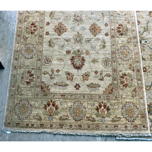 12 - Two Turkish rugs, decorated with floral designs, on cream coloured grounds  39