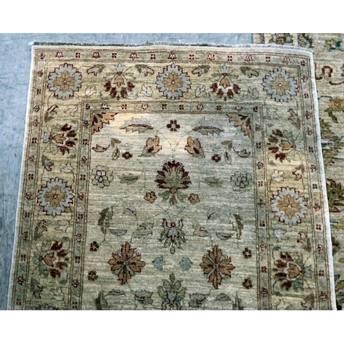 12 - Two Turkish rugs, decorated with floral designs, on cream coloured grounds  39