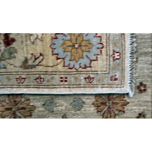 12 - Two Turkish rugs, decorated with floral designs, on cream coloured grounds  39