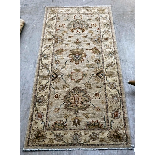 12 - Two Turkish rugs, decorated with floral designs, on cream coloured grounds  39