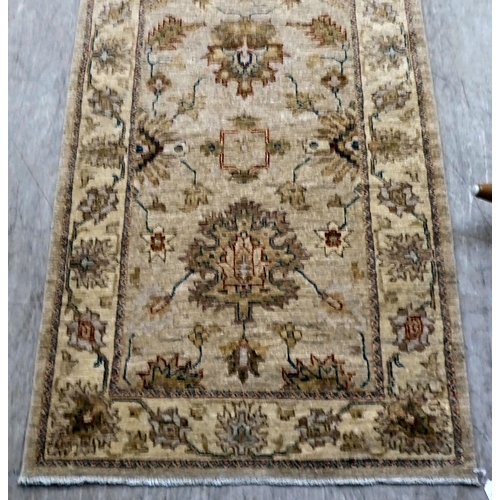 12 - Two Turkish rugs, decorated with floral designs, on cream coloured grounds  39