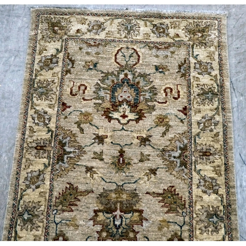 12 - Two Turkish rugs, decorated with floral designs, on cream coloured grounds  39