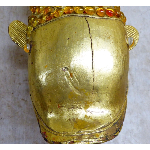 151 - A modern antique finished, gilt painted, carved wooden and amber coloured model carp, on stilts and ... 