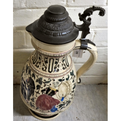 39 - A Bavarian pottery and metal lidded Stein, decorated with a jovial tavern scene  17