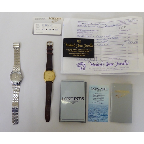 421 - A Timex steel cased and strapped wristwatch, faced by a baton dial; and another Longines gold plated... 