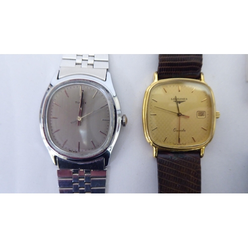 421 - A Timex steel cased and strapped wristwatch, faced by a baton dial; and another Longines gold plated... 