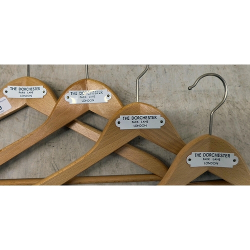 60 - Four coat hangers, each bearing a plaque for The Dorchester Hotel, Park Lane, London