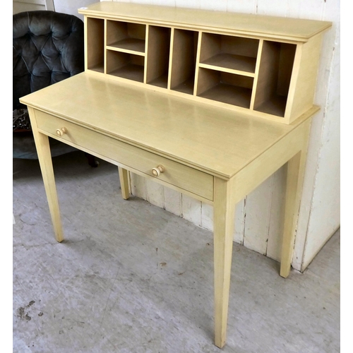 64 - A modern cream wash painted desk with a pigeonhole upstand, over a long drawer, raised on square, ta... 