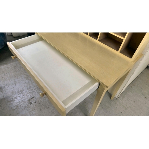 64 - A modern cream wash painted desk with a pigeonhole upstand, over a long drawer, raised on square, ta... 