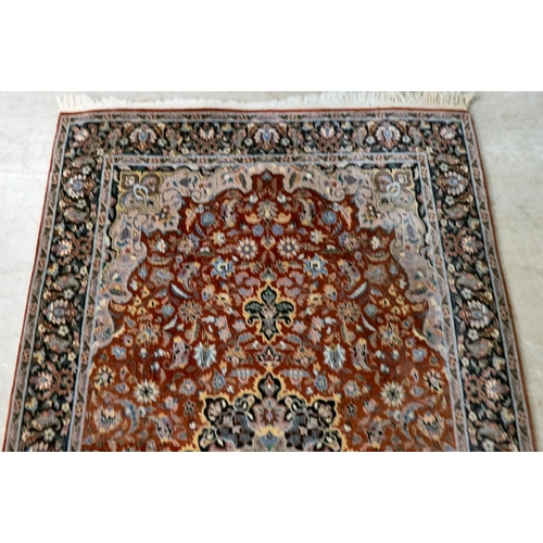 9 - A Persian rug, profusely decorated with floral designs, on a multi-coloured ground  56