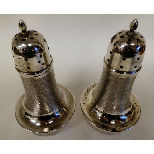 166 - A pair of silver casters of covered vase design with part engine turned decoration, caps and flame f... 