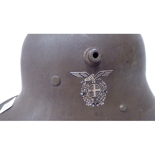 170 - A German World War II steel helmet with decal, hide liner and chinstrap (Please Note: this lot ... 