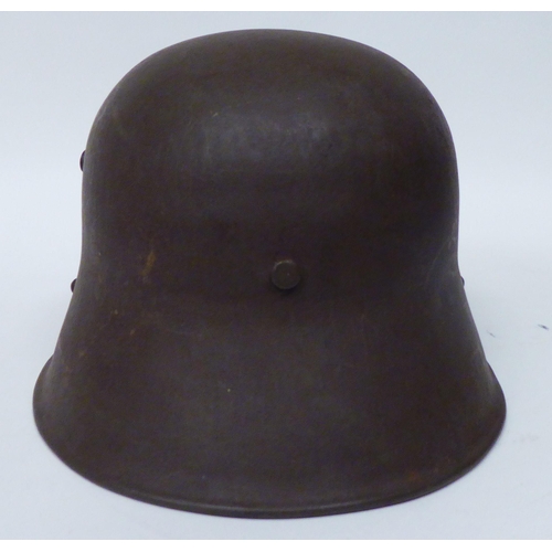 170 - A German World War II steel helmet with decal, hide liner and chinstrap (Please Note: this lot ... 