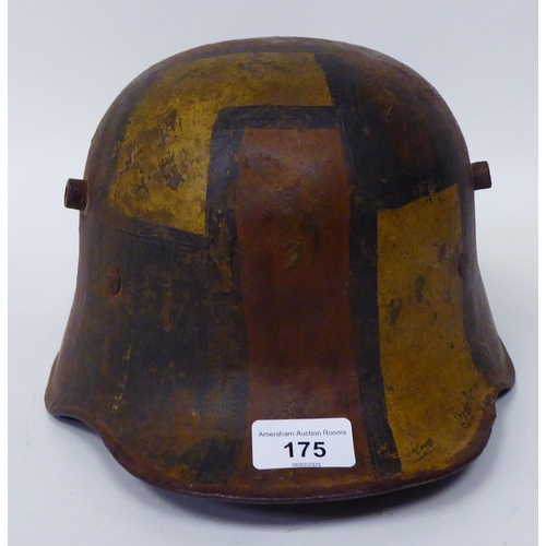 175 - A German World War I painted steel helmet with a hide liner and chinstrap(Please Note: this lot is s... 