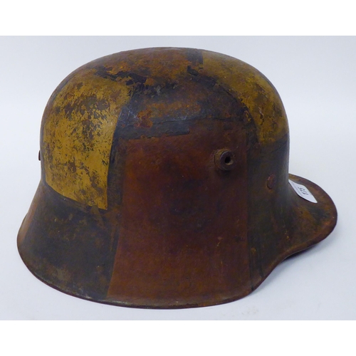 175 - A German World War I painted steel helmet with a hide liner and chinstrap(Please Note: this lot is s... 