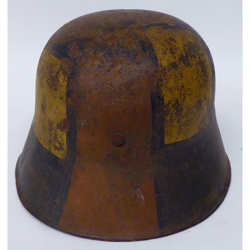 175 - A German World War I painted steel helmet with a hide liner and chinstrap(Please Note: this lot is s... 