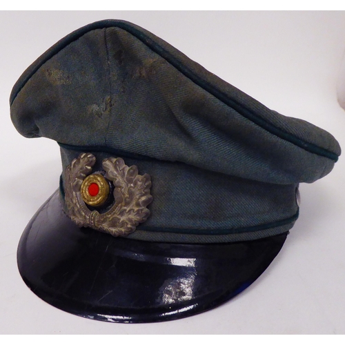 177 - Military items, some copies: to include a steel helmet with a camouflage cover; assorted buttons; an... 