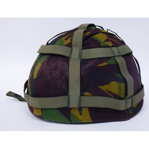 177 - Military items, some copies: to include a steel helmet with a camouflage cover; assorted buttons; an... 