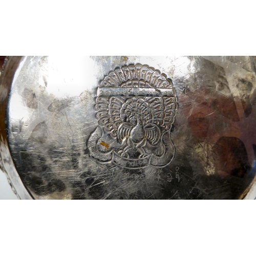 18 - An Asian white metal bowl, cast, embossed and chased with figures, wild animals, stiff leaf and othe... 