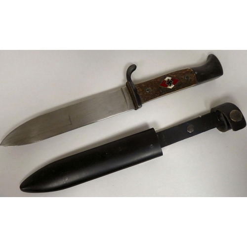 180 - A German Hitler Youth knife with a two-part handgrip and enamelled emblem, the blade 5.5