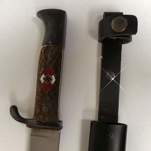 180 - A German Hitler Youth knife with a two-part handgrip and enamelled emblem, the blade 5.5