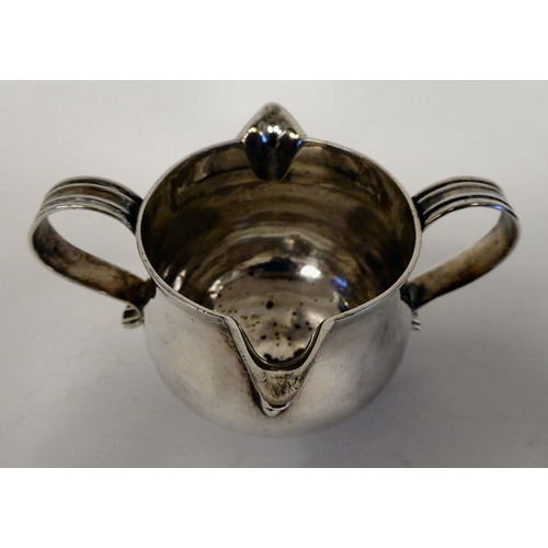 181 - An Edwardian silver cream jug of tapered, bulbous form with opposing pouring lips and twin S-shaped ... 