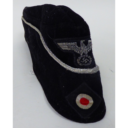 182 - A German Army black side cap with emblems(Please Note: this lot is subject to the statement made in ... 