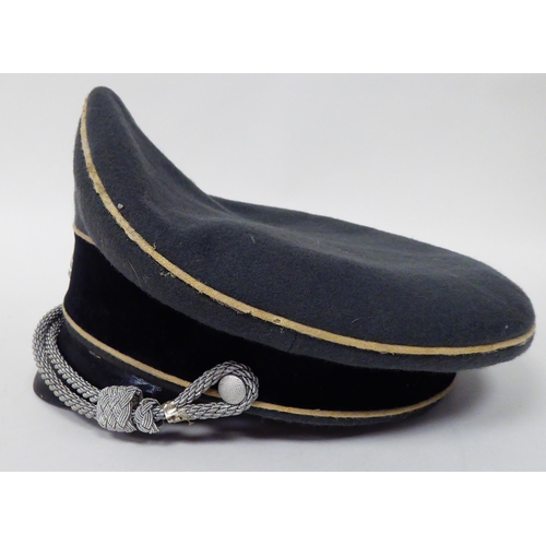 183 - A German SS peaked cap with white piping(Please Note: this lot is subject to the statement made in t... 