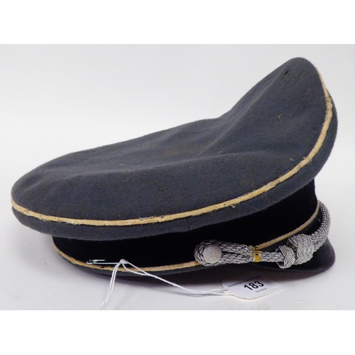 183 - A German SS peaked cap with white piping(Please Note: this lot is subject to the statement made in t... 