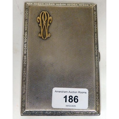 186 - A silver folding cigarette case with engine turned decoration, chamfered bellflower cast borders, on... 