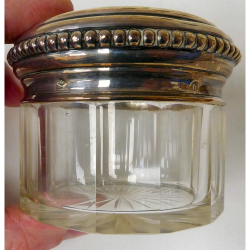 22 - A set of four 19thC silver coloured metal mounted, facet cut glass dressing table jars with bead bor... 