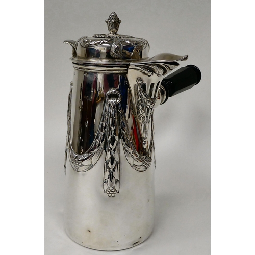 27 - A Continental silver coloured metal chocolate pot of tapered form with an angled handle and an eboni... 