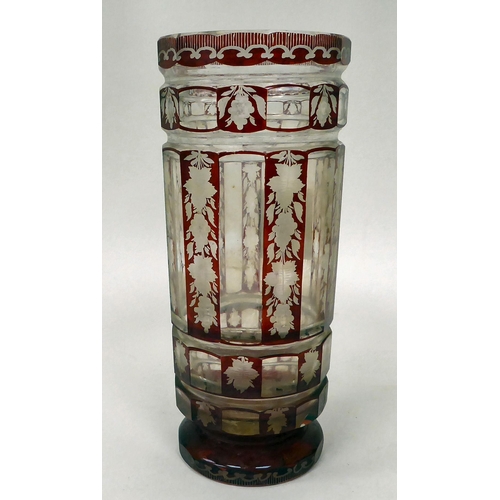 29 - A late 19thC Bohemian cut and engraved ruby coloured glass vase of cylindrical form, decorated in pa... 