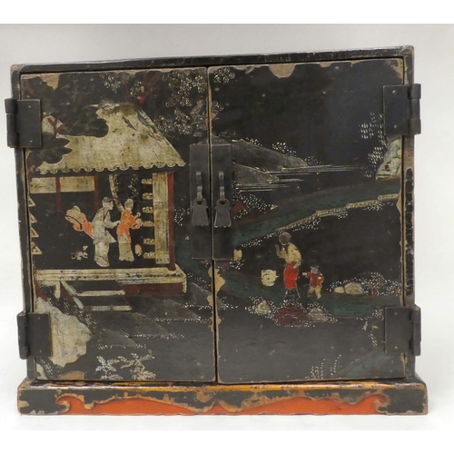 333 - An 18thC Chinese black lacquered and overpainted officials table top cabinet with two doors, decorat... 