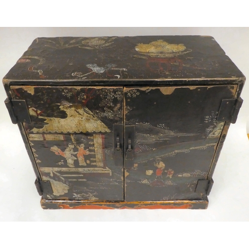 333 - An 18thC Chinese black lacquered and overpainted officials table top cabinet with two doors, decorat... 