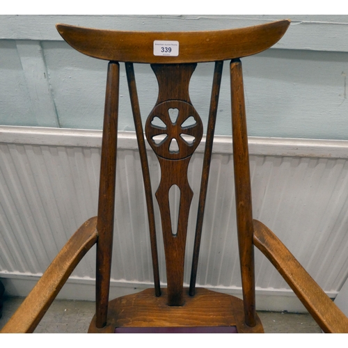 339 - A set of four mid 20thC stained beech framed dining chairs, each with a wheel splat and drop-in seat... 