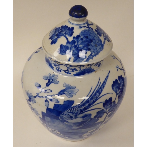 44 - A 20thC Chinese porcelain, baluster shape vase and cover, decorated in blue and white with exotic bi... 