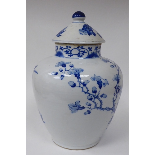 44 - A 20thC Chinese porcelain, baluster shape vase and cover, decorated in blue and white with exotic bi... 