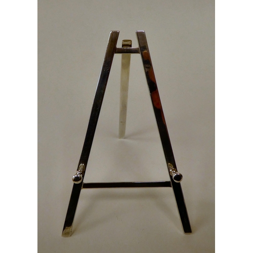 45 - A miniature, glazed silver photograph frame, on a folding easel  RC  London 1994  2.5... 