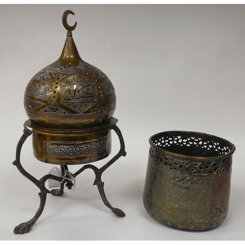 65 - A late 19th/early 20thC Cairo ware pot and cover, on a tripod stand, decorated in Islamic taste  ove... 