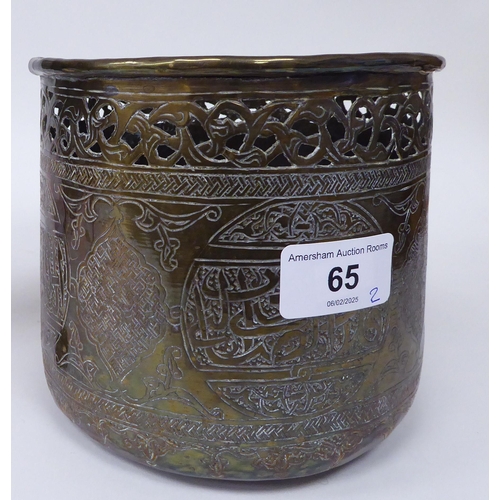 65 - A late 19th/early 20thC Cairo ware pot and cover, on a tripod stand, decorated in Islamic taste  ove... 