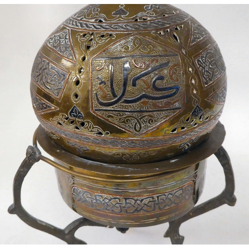 65 - A late 19th/early 20thC Cairo ware pot and cover, on a tripod stand, decorated in Islamic taste  ove... 