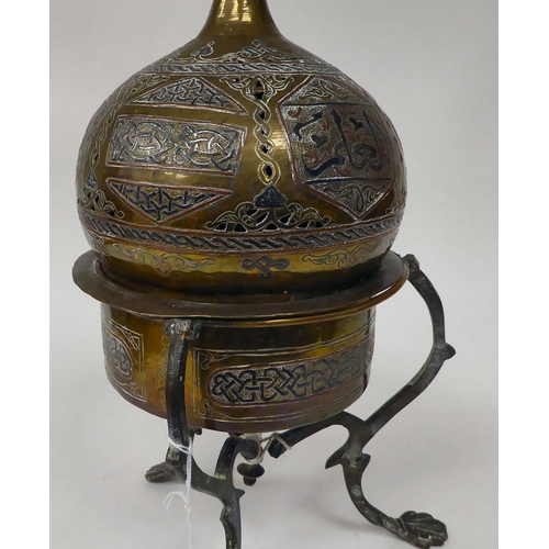 65 - A late 19th/early 20thC Cairo ware pot and cover, on a tripod stand, decorated in Islamic taste  ove... 