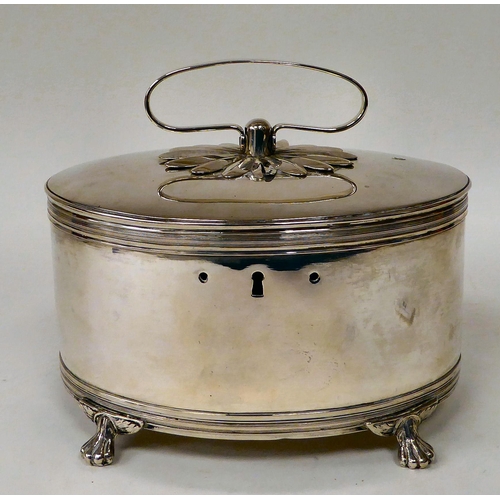 81 - A white metal oval biscuit box with a folding top handle and hinged lid, on claw feet  7.5