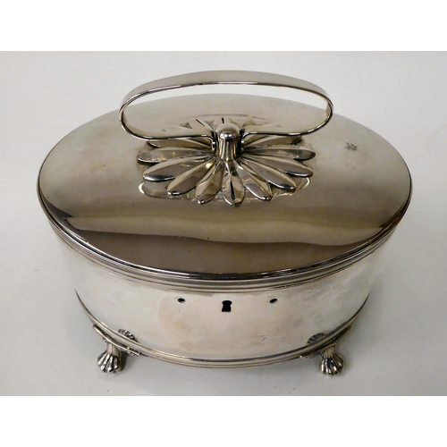 81 - A white metal oval biscuit box with a folding top handle and hinged lid, on claw feet  7.5