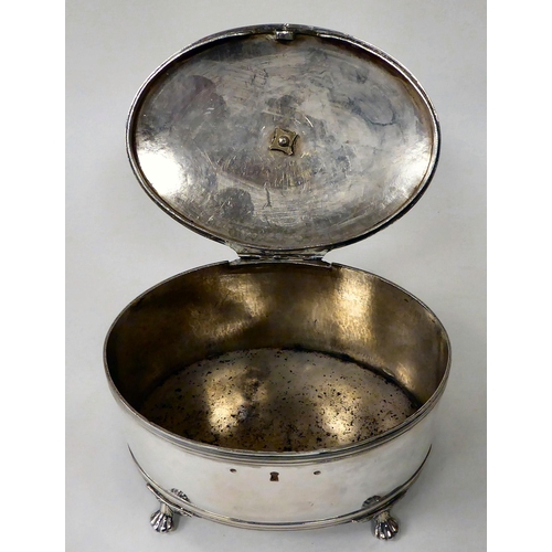 81 - A white metal oval biscuit box with a folding top handle and hinged lid, on claw feet  7.5