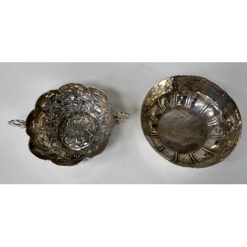 82 - A Mexican silver coloured metal bowl of lobed form, engraved with a frieze of flora and animals ... 