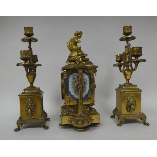 1 - A circa 1880 French gilt brass cased, three piece clock garniture, set with overpainted porcelain pl... 