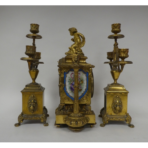 1 - A circa 1880 French gilt brass cased, three piece clock garniture, set with overpainted porcelain pl... 