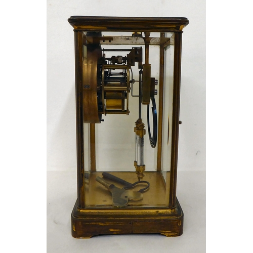 117 - A late 19thC French four glass brass cased mantel clock; the mercurial pendulum driven movement face... 